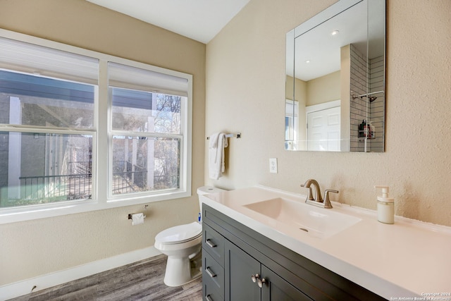 bathroom featuring hardwood / wood-style floors, vanity, toilet, and a healthy amount of sunlight