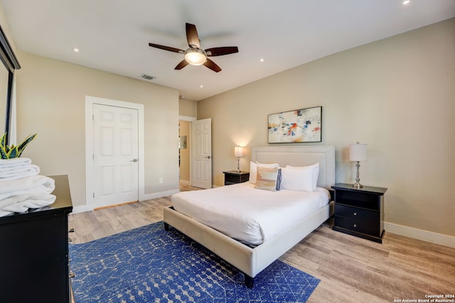 bedroom with ceiling fan and light hardwood / wood-style floors