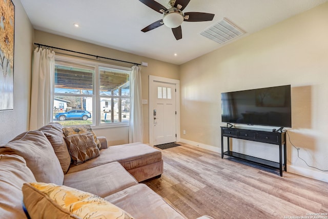 living room featuring ceiling fan and light wood-type flooring