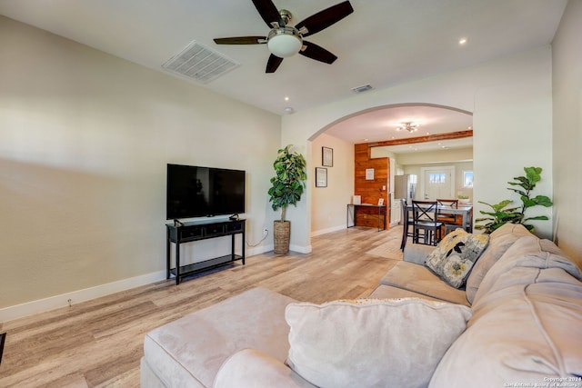 living room featuring light hardwood / wood-style flooring and ceiling fan