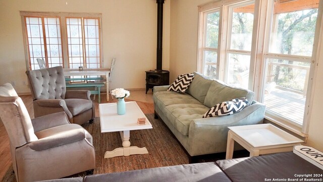 living room with hardwood / wood-style flooring and a wood stove