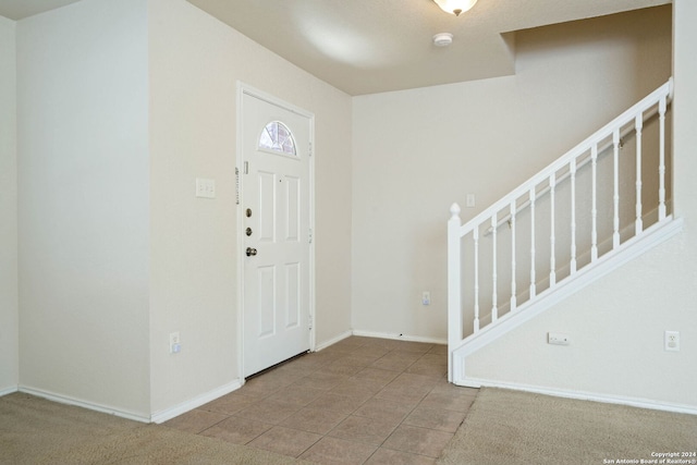 foyer entrance with light carpet