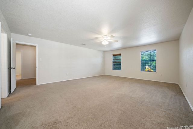 carpeted empty room featuring a textured ceiling and ceiling fan