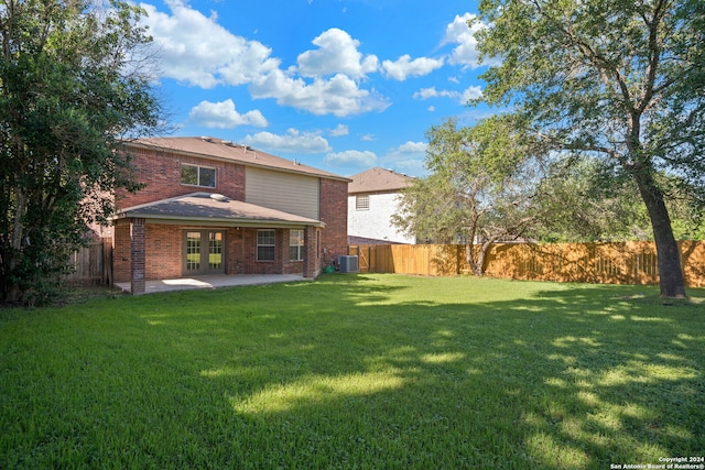 exterior space with central AC, a yard, and a patio