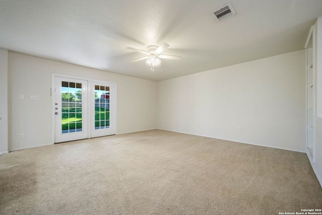 empty room with light carpet and ceiling fan