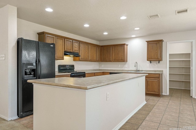 kitchen with black appliances, a textured ceiling, sink, a center island, and light tile floors