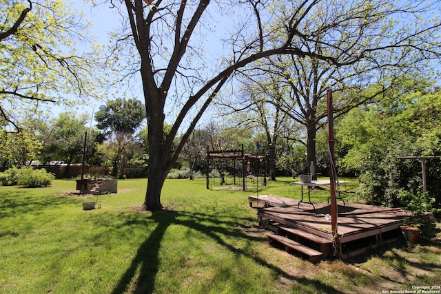 view of yard with a deck and a fire pit