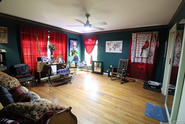 living room with crown molding, ceiling fan, and hardwood / wood-style floors