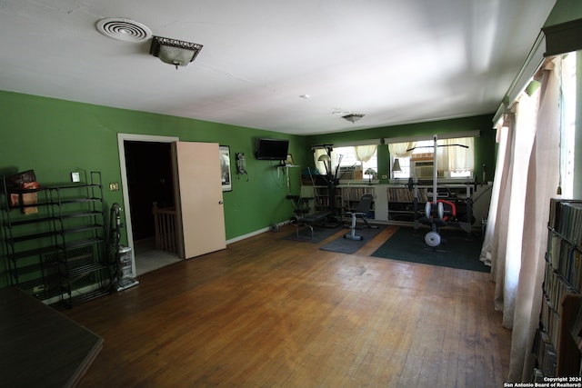 exercise area featuring dark wood-type flooring