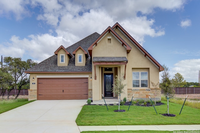 view of front of house with a front yard and a garage