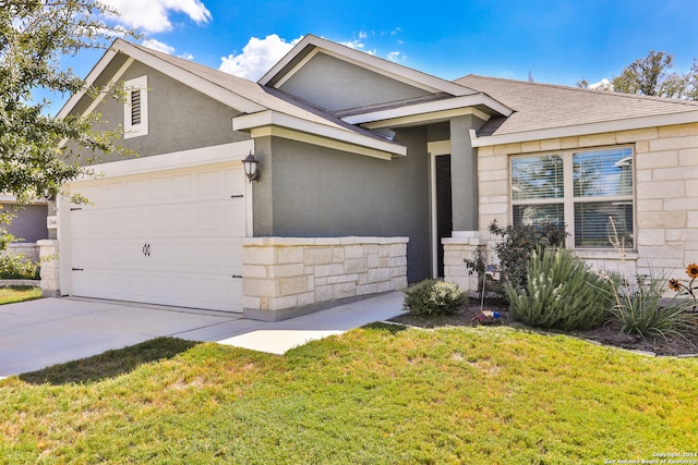 view of front of house with a garage and a front yard