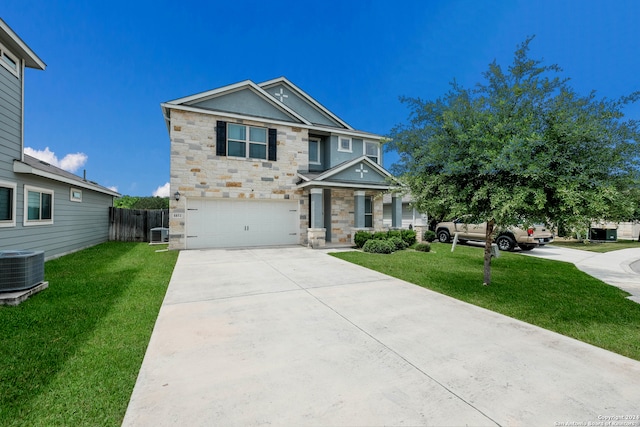 view of front facade featuring a front lawn, a garage, and central AC