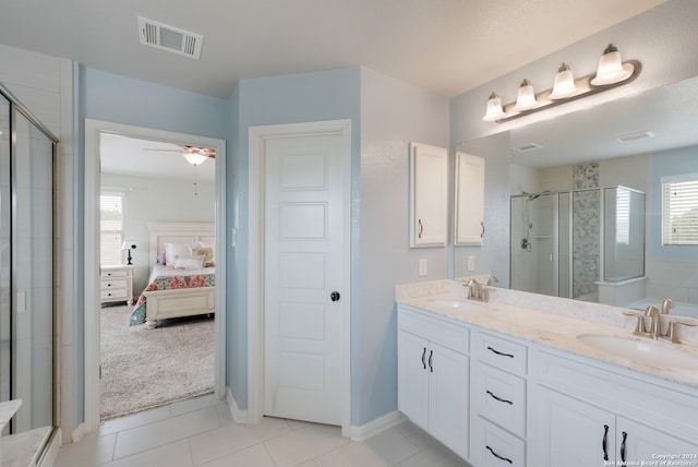 bathroom with walk in shower, ceiling fan, dual vanity, and tile flooring