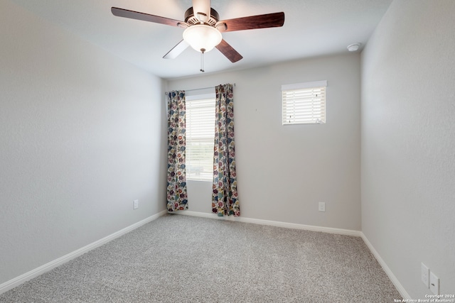 spare room featuring light carpet and ceiling fan