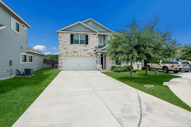 view of front of house with a garage, central air condition unit, and a front yard