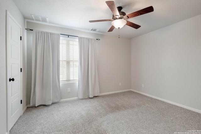 carpeted spare room featuring ceiling fan