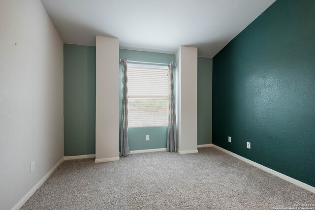 empty room featuring light carpet