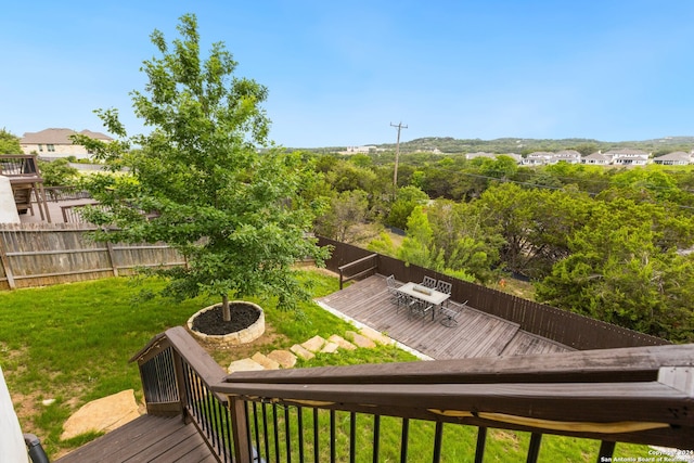 wooden terrace featuring a lawn