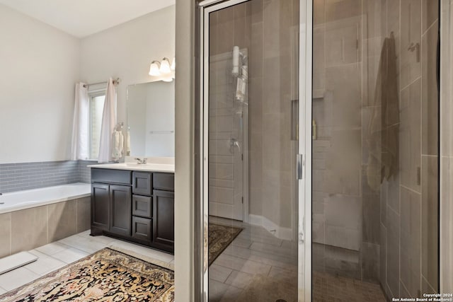 bathroom featuring vanity, separate shower and tub, and tile floors