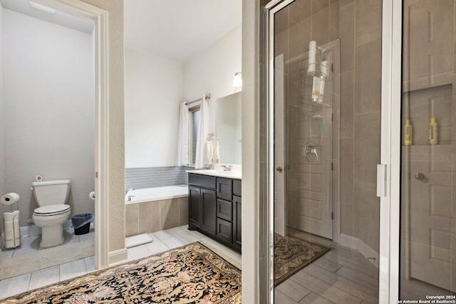 full bathroom with vanity, tile floors, toilet, and shower with separate bathtub