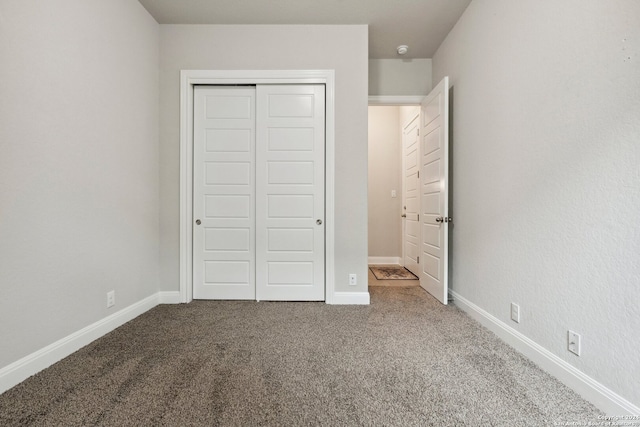 unfurnished bedroom with a closet and carpet floors