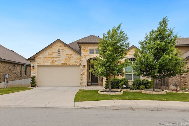 view of front of home featuring a front lawn and a garage