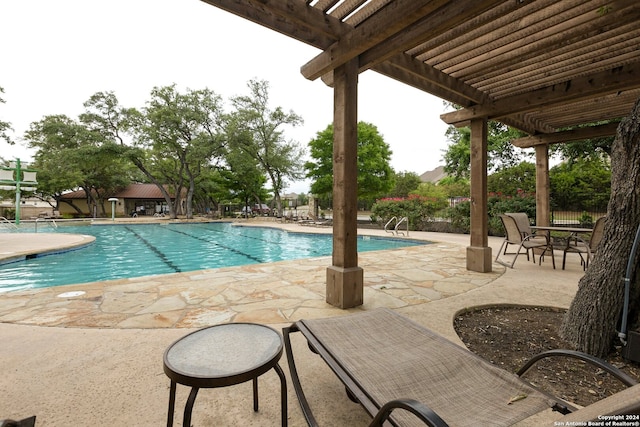 view of swimming pool featuring a patio area and a pergola