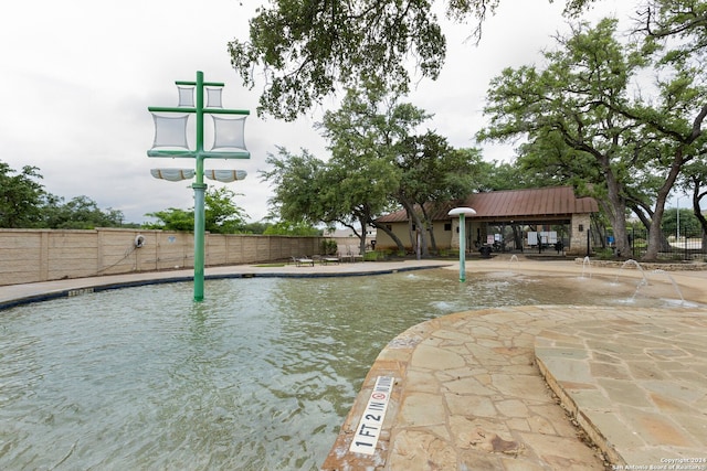 view of sport court with a community pool