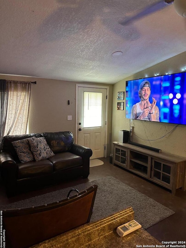 living room featuring dark colored carpet, a textured ceiling, and lofted ceiling