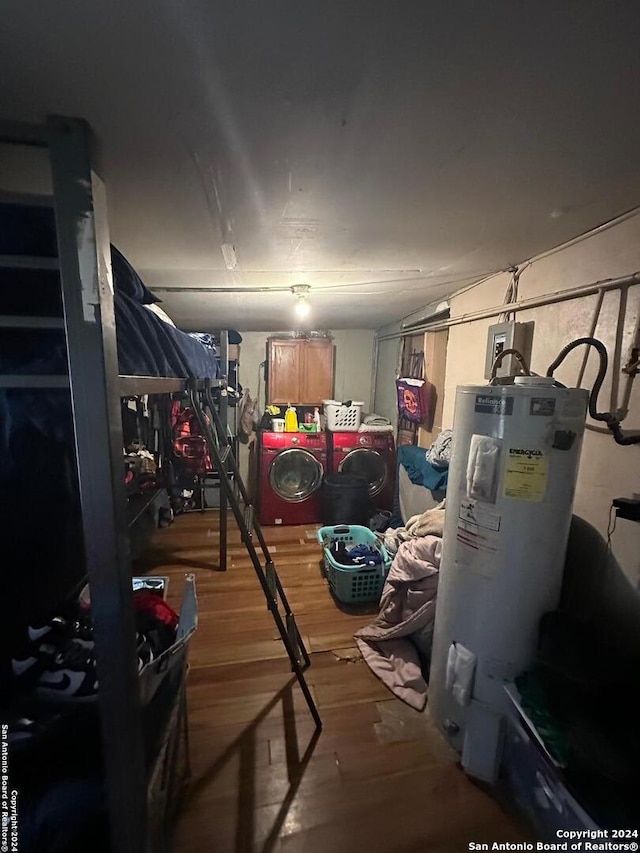 storage area featuring water heater and washing machine and clothes dryer