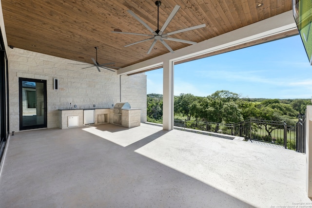 view of patio / terrace with an outdoor kitchen, ceiling fan, and grilling area