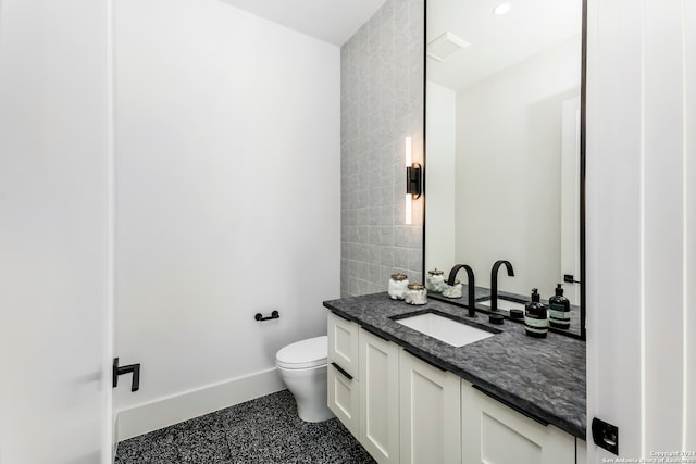 bathroom featuring tile floors, vanity with extensive cabinet space, and toilet