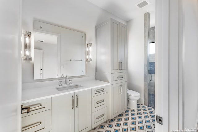 bathroom with toilet, tile flooring, and vanity