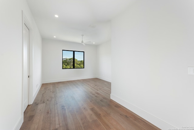 empty room with light hardwood / wood-style flooring and ceiling fan