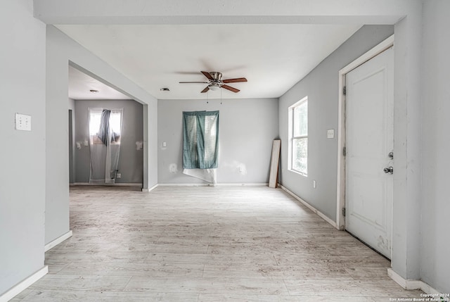 empty room with light hardwood / wood-style floors and ceiling fan