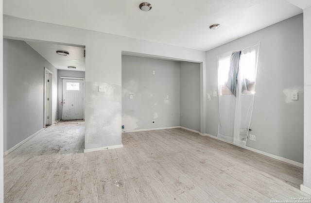 spare room with light wood-type flooring and a wealth of natural light