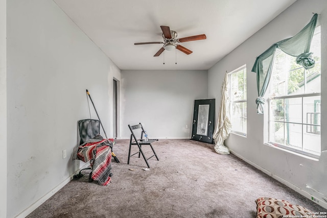 playroom with a wealth of natural light, ceiling fan, and carpet flooring