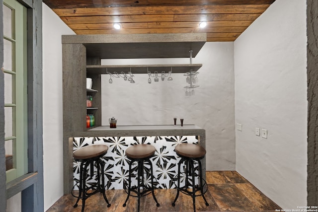 bar featuring wood ceiling and vaulted ceiling