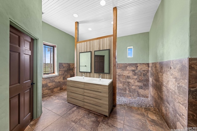 bathroom featuring tile walls, tile floors, and vanity with extensive cabinet space