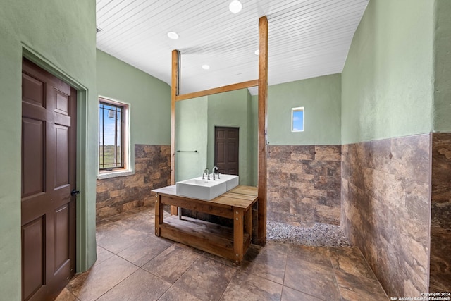 bathroom featuring sink, tile walls, and tile floors