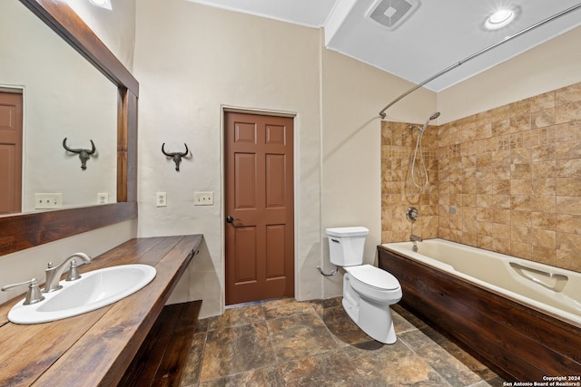 full bathroom featuring tiled shower / bath, toilet, tile floors, and large vanity