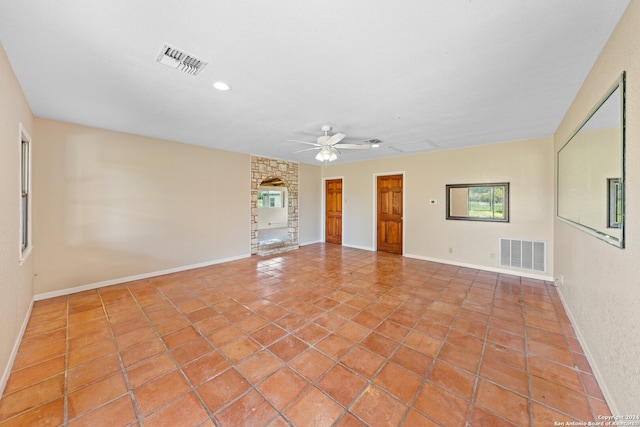 spare room featuring ceiling fan and light tile floors