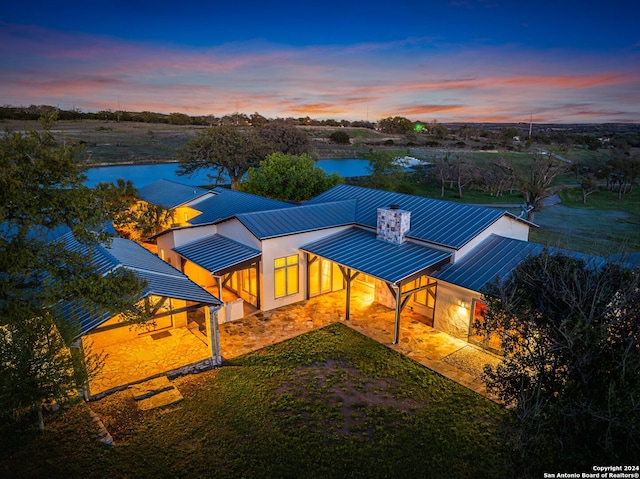 aerial view at dusk with a water view