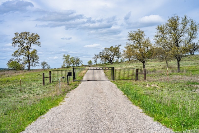 view of gate with a rural view