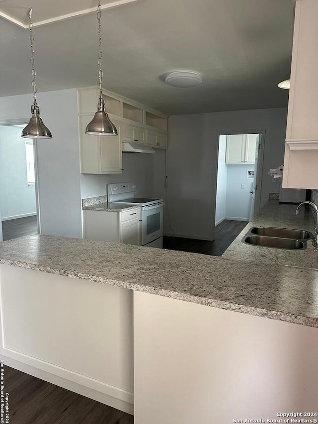 kitchen featuring electric range, dark wood-type flooring, sink, decorative light fixtures, and light stone counters