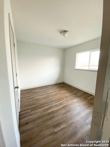 spare room featuring dark hardwood / wood-style floors