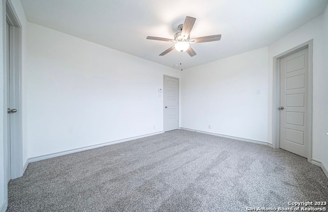 carpeted empty room with ceiling fan