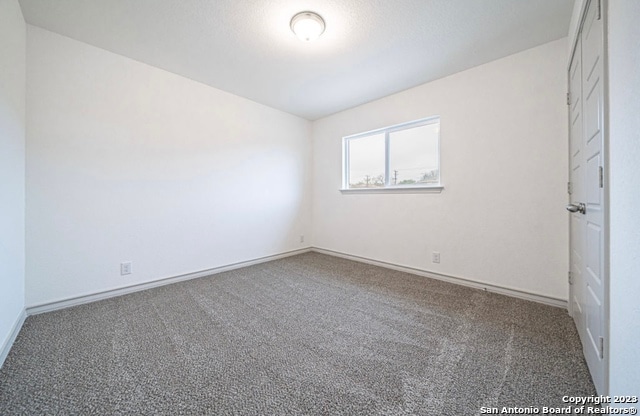 empty room with carpet flooring