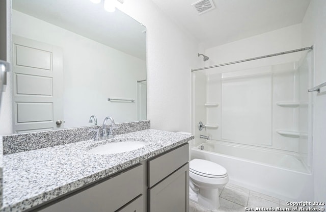 full bathroom featuring large vanity, shower / tub combination, tile floors, and toilet