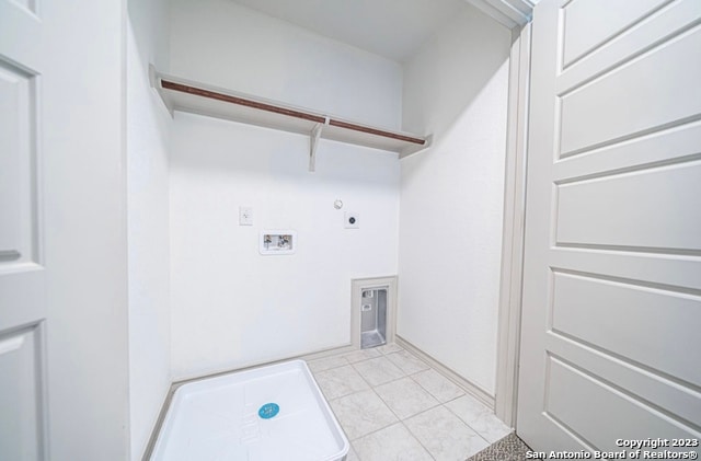 clothes washing area featuring hookup for a gas dryer, hookup for a washing machine, hookup for an electric dryer, and light tile floors